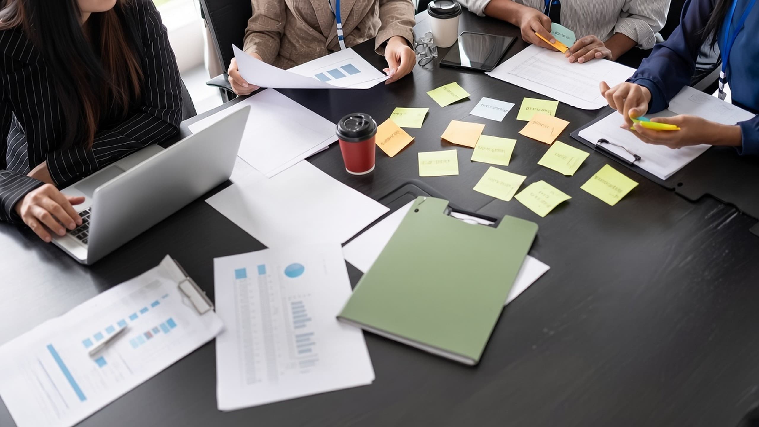 People working together at a table with notes